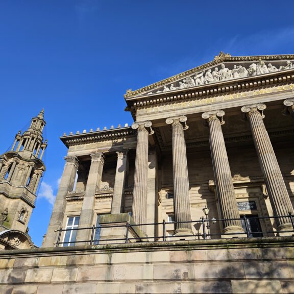 An exterior view of the Harris and Sessions House with blue sky in the background.