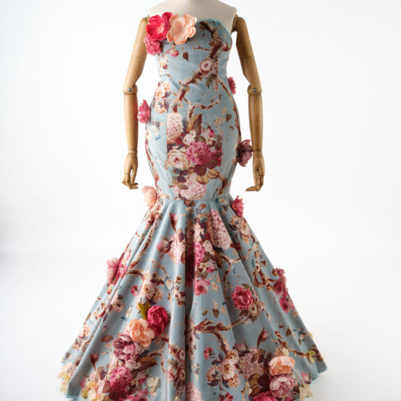A pale blue dress decorated with pink roses.