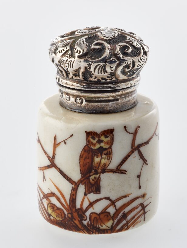 White scent bottle with illustration of an owl.