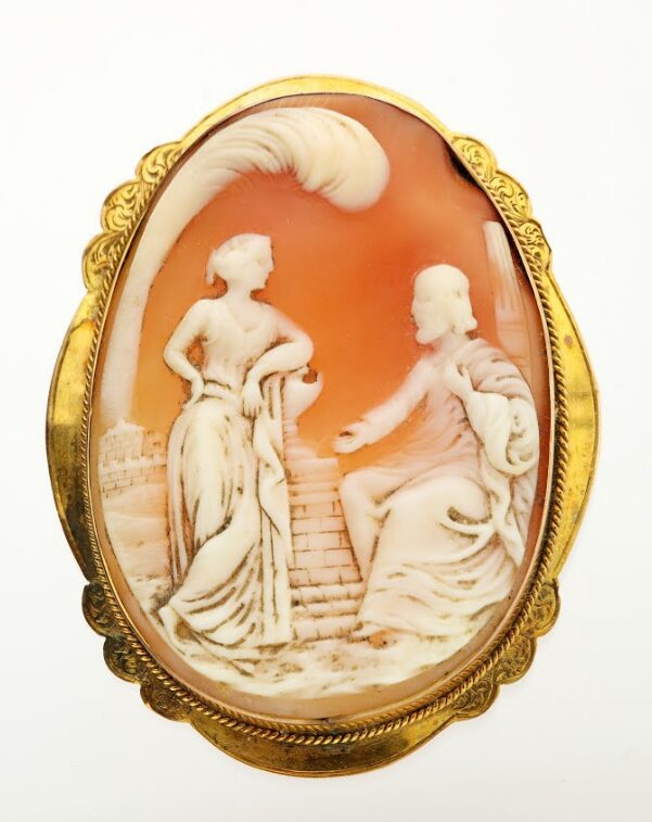Brooch in an oval design crafted from amber and white, likely made from sardonyx