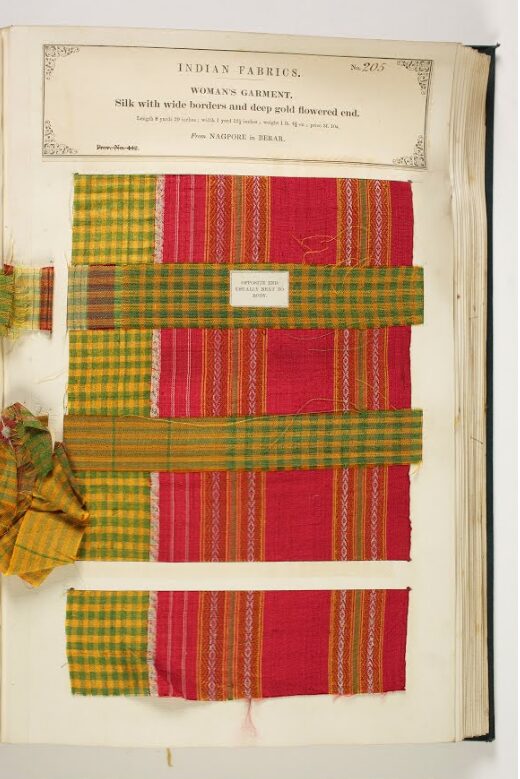 Red, green and yellow fabric sample within a large book