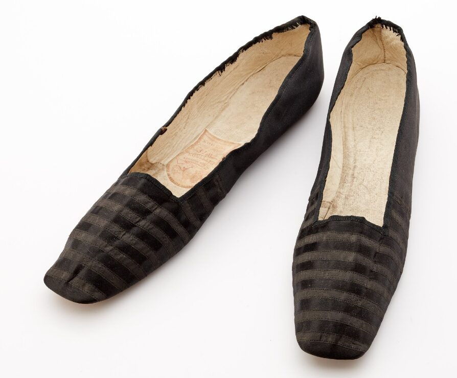 Black silk evening slippers, stitched with a striped black ribbon decoration