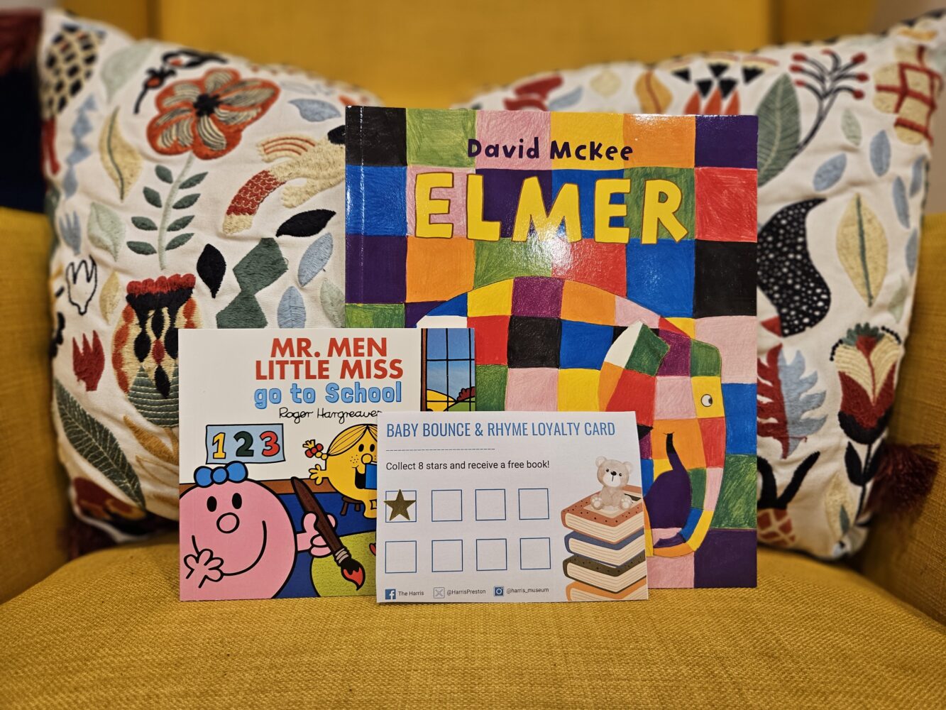 A yellow chair with colourful books.