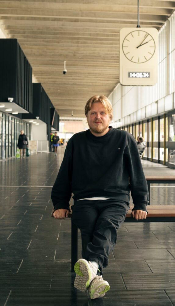 Image of a man sat at Preston Bus Station.
