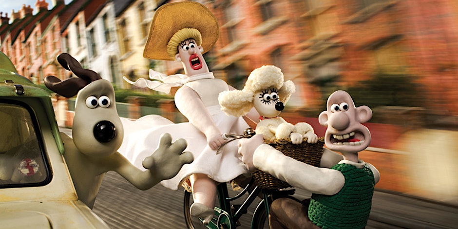 Wallace, Gromit and other characters moving quickly down a street.