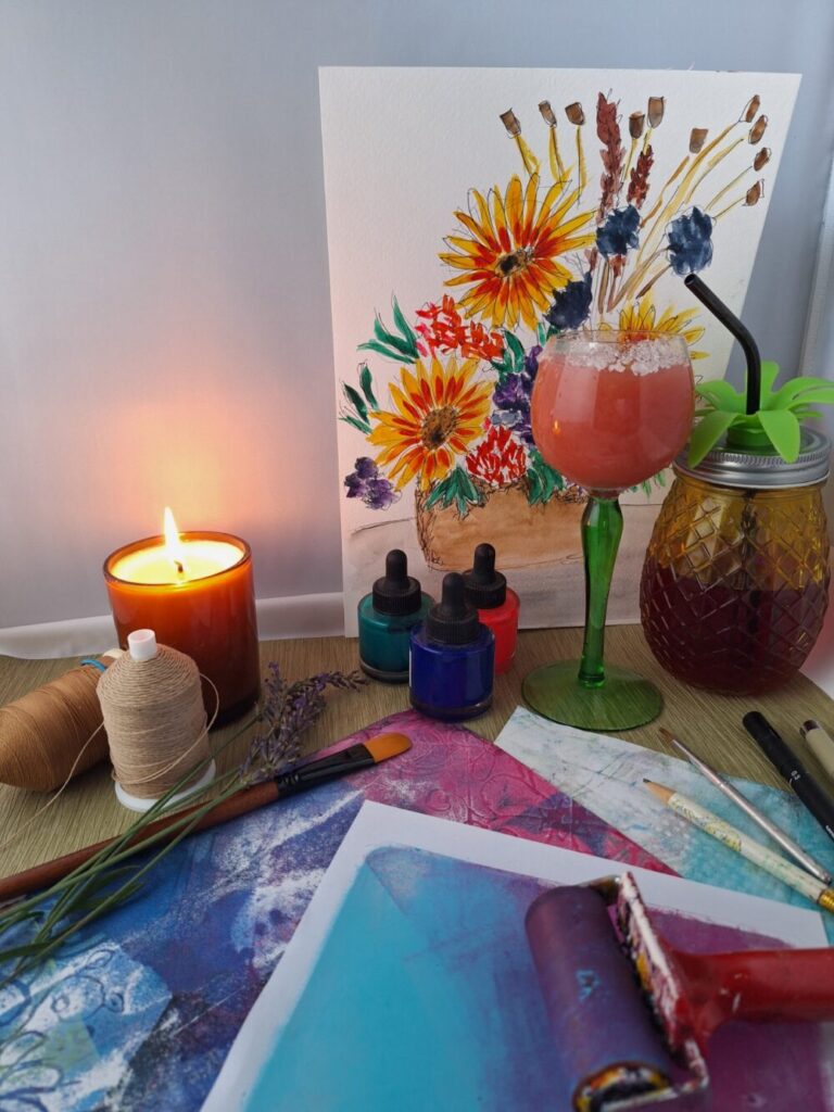 Colourful prints and a painting of flowers accompanied by a mocktail.