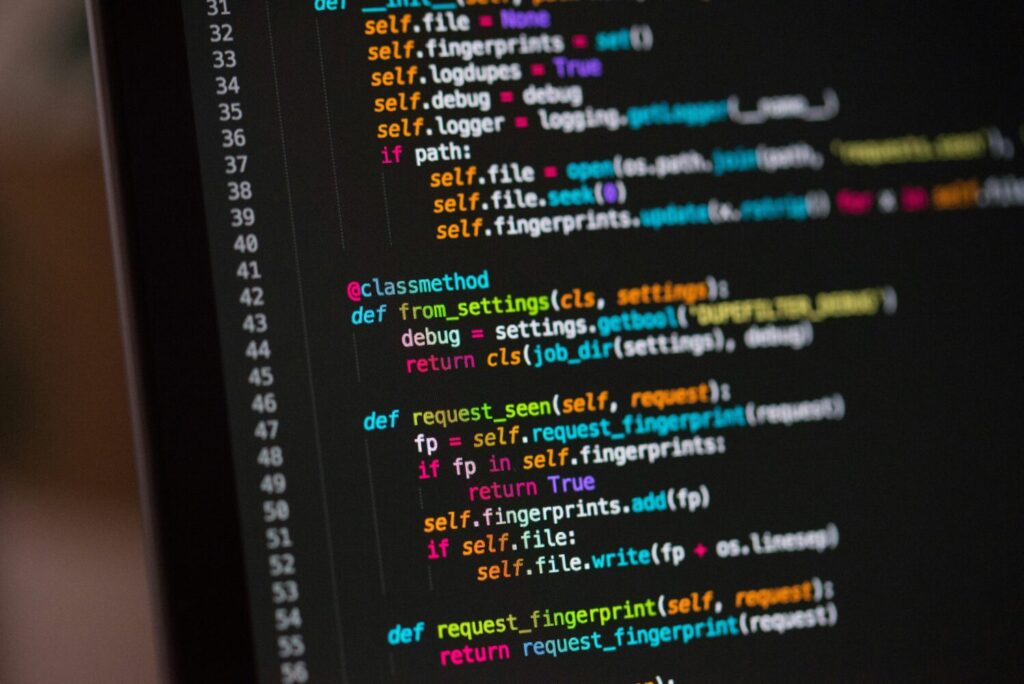 A black screen featuring coding text.