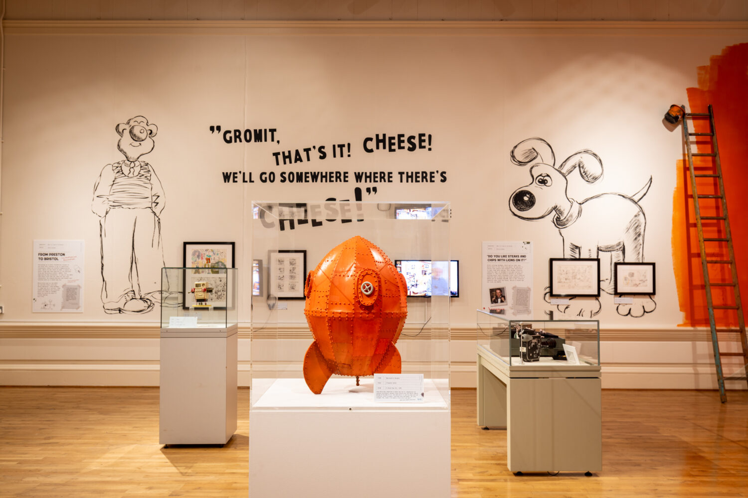 Image of the exhibition featuring a orange rocket.