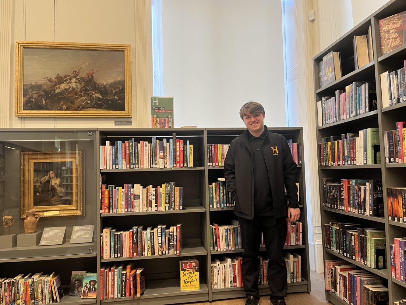 Image of a Harris worker amongst library books.