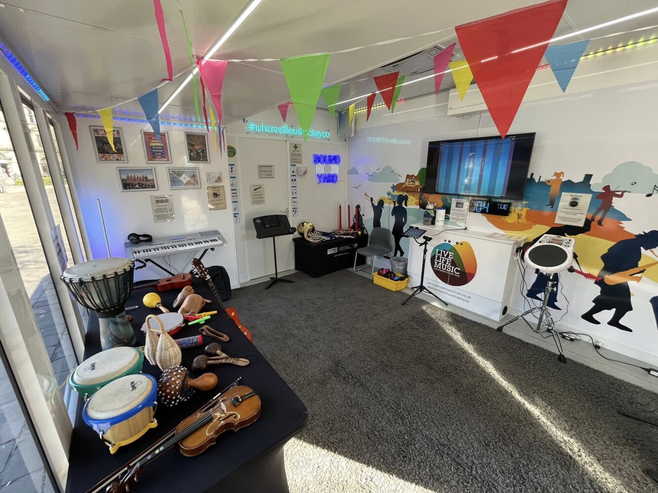 Image of a music room with instruments laid out around the sides.