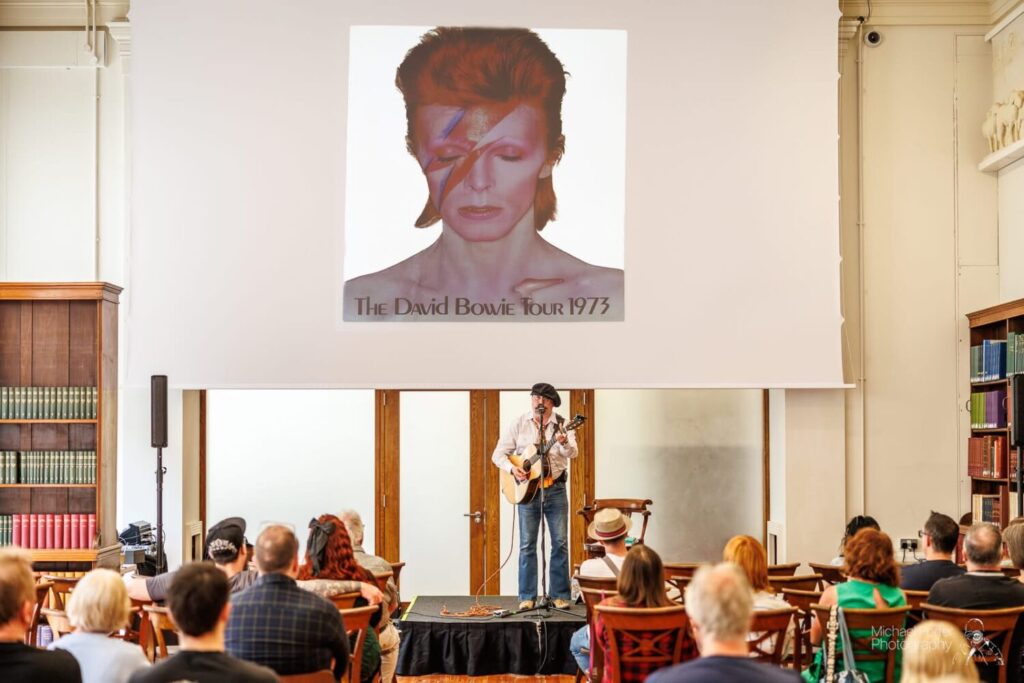 Interative presentation with a man playing a guitar.