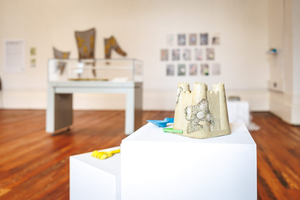 Image of a sandcastle shaped art installation. 
