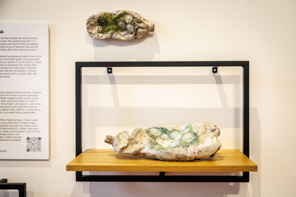 Image of a reclaimed plastic bottle with a green artwork added.