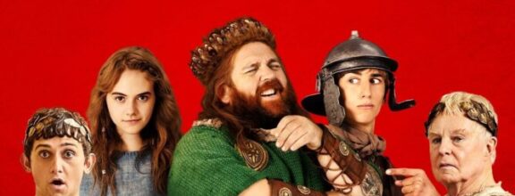 Poster for "Horrible Histories: The Movie - Rotten Romans" features costumed characters against a red background, with comedic expressions and bold, stylized text.