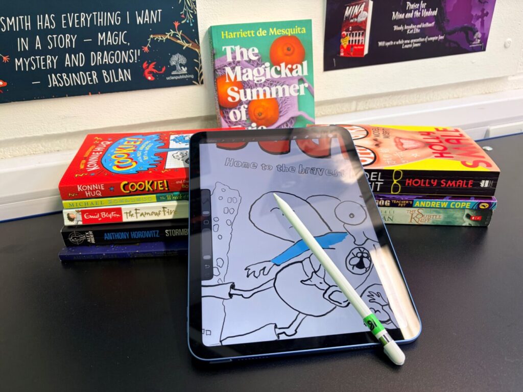 Image of a pile of books with an Ipad and pen.