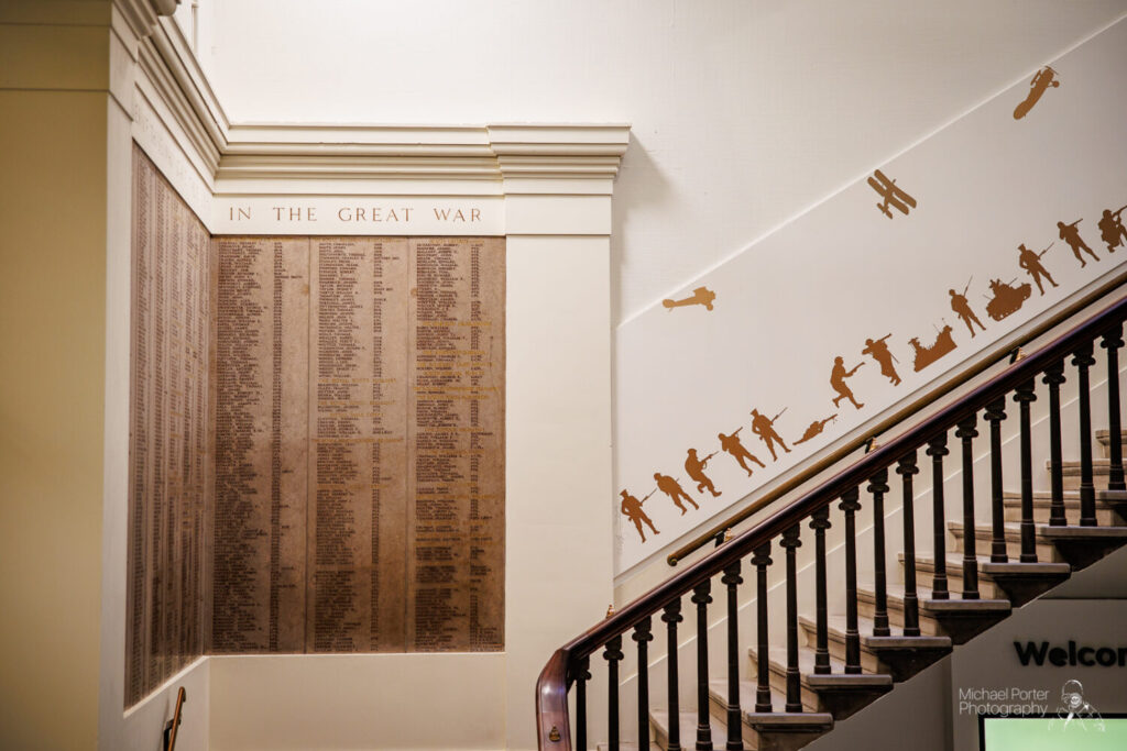 The Roll of Honour and a set of staircases which includes brown collage prints,