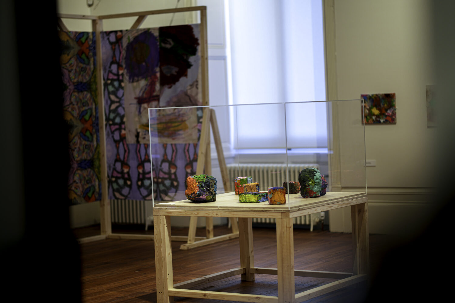 Image of artworks in a glass display case.