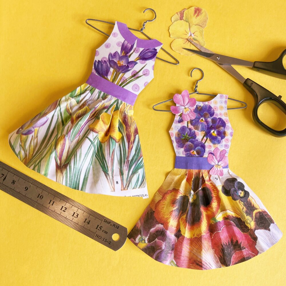 Image of two paper dresses with floral patterns,