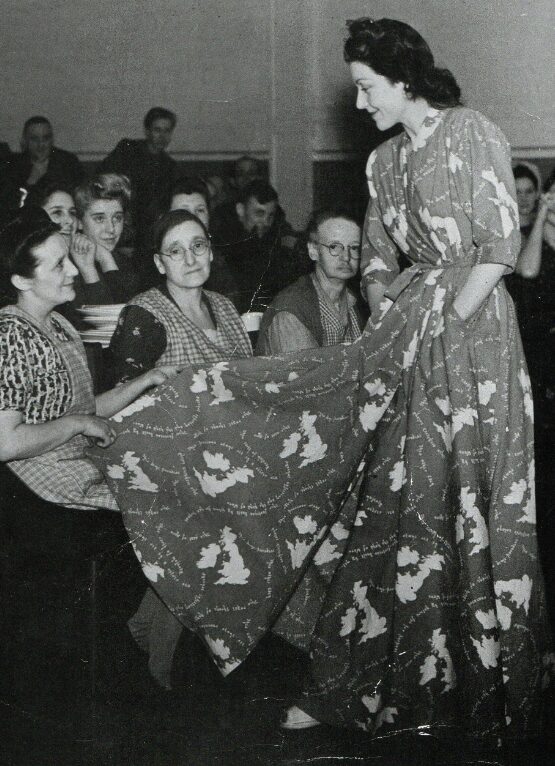 Image of a women wearing a Housecoat with a world map patten.