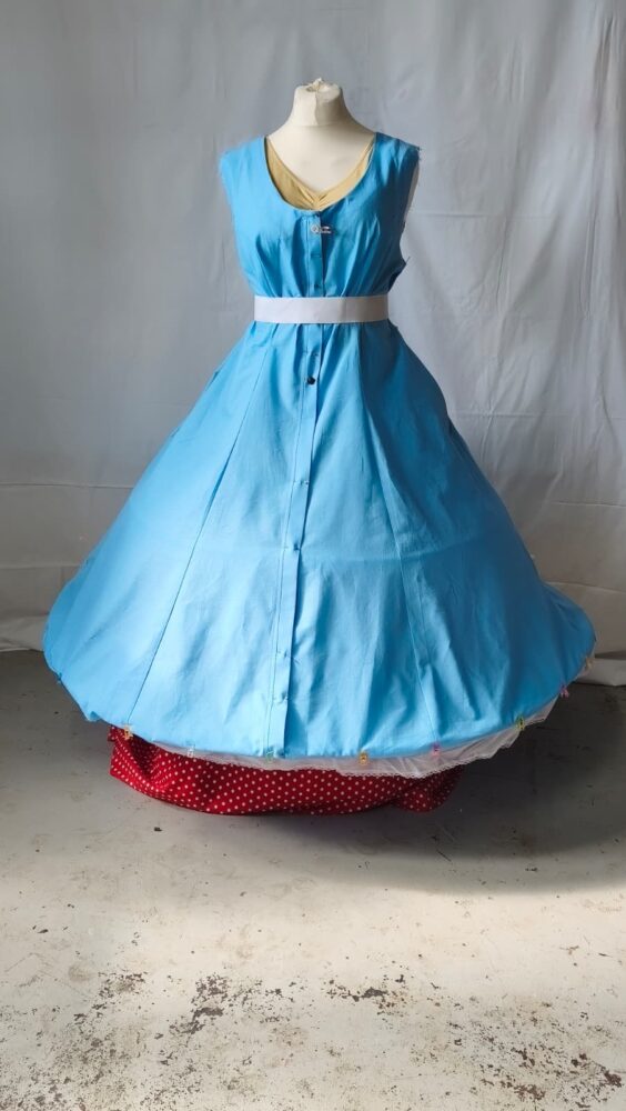 Image of a large baby blue dress with a white belt
