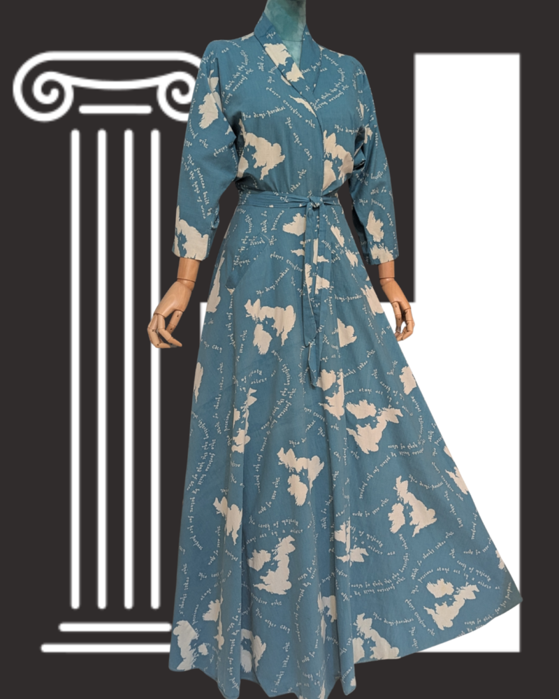 Blue wrap dress with white cloud-like patterns and handwritten text, displayed on a mannequin against a dark background with a white column illustration.