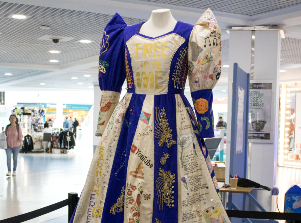 Image of a blue and white dress in display.