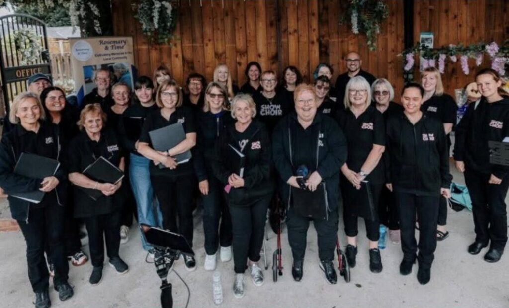 Image of a choir dressed in back stood in lines.